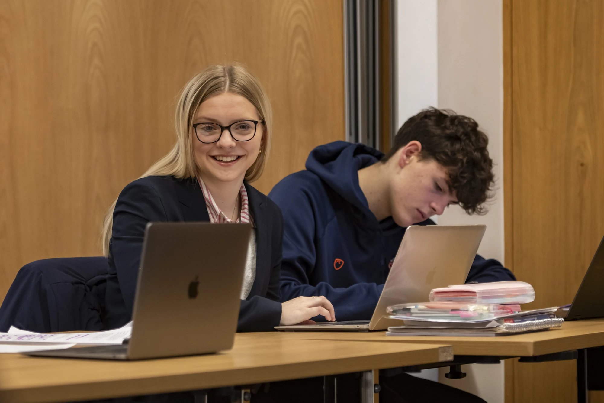 Barnard Castle School Sixth Form pupils sat at a desk with laptops and notebooks.