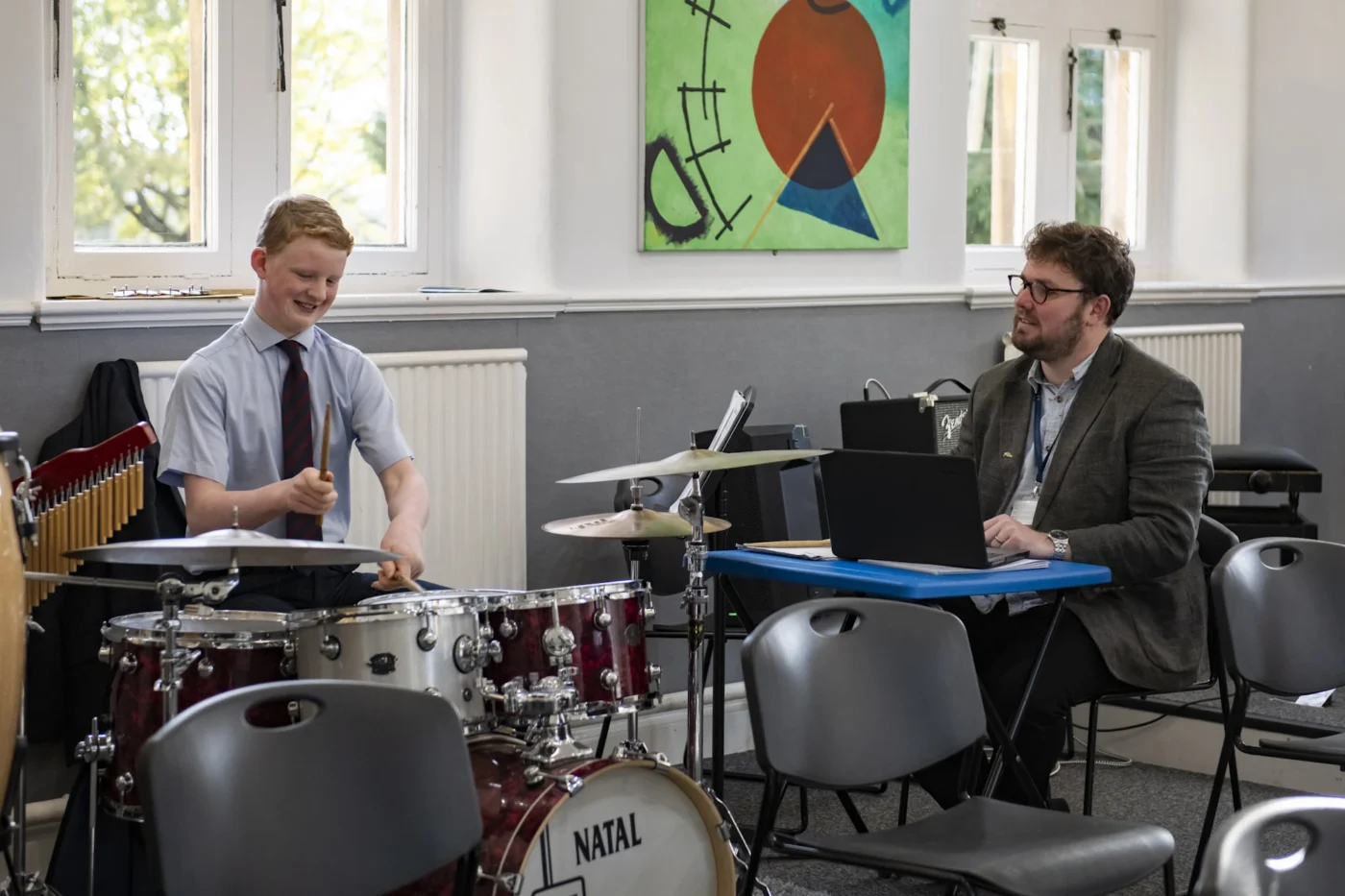 A Barnard Castle School pupil having a music lesson learning how to play the drums with an instructor.