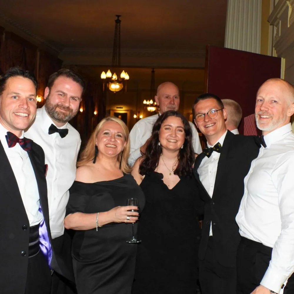 A group of Old Barnardians in formal attire at an event.