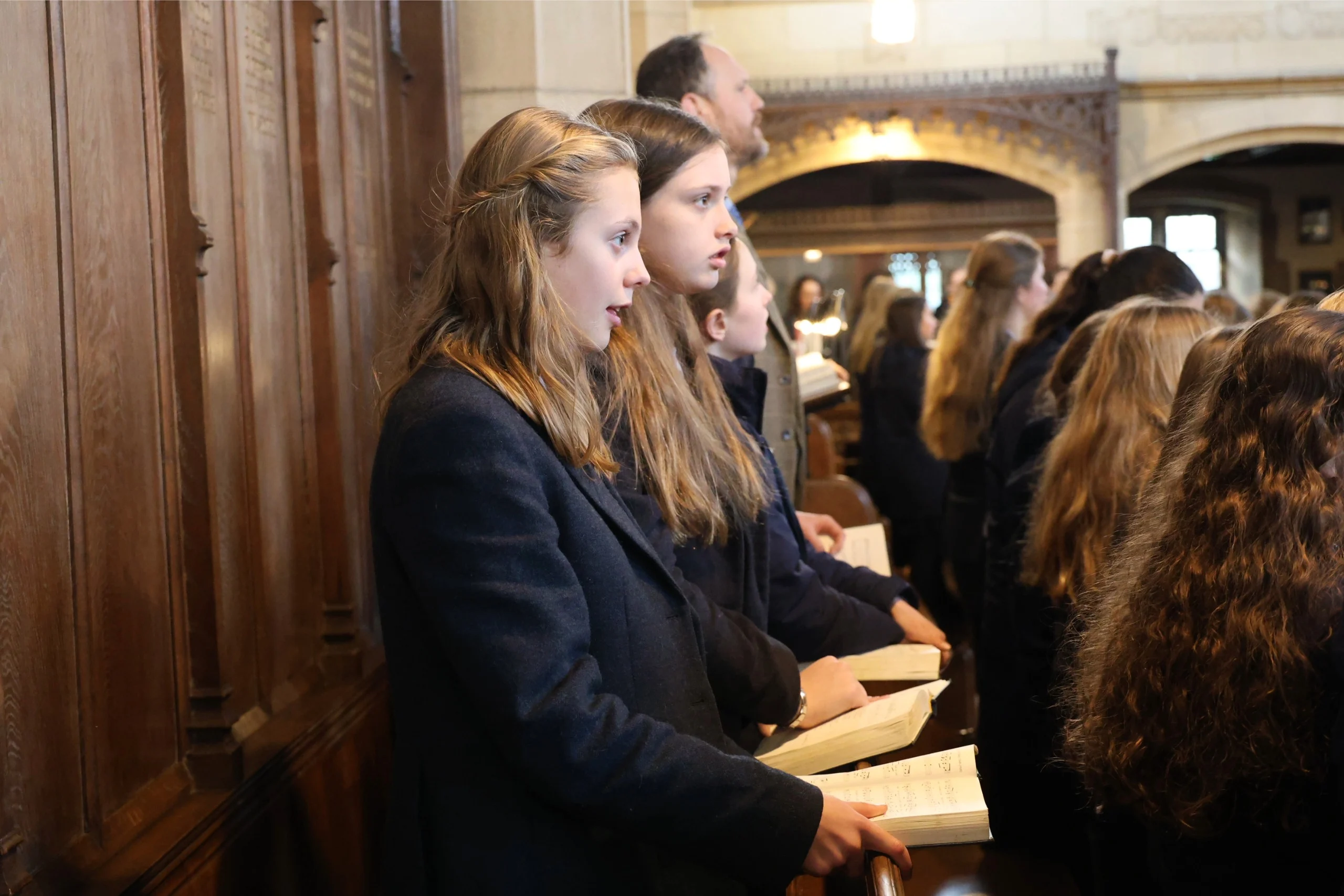 A row of Barney students singing a hymn during the 2026 Headmaster's Address.