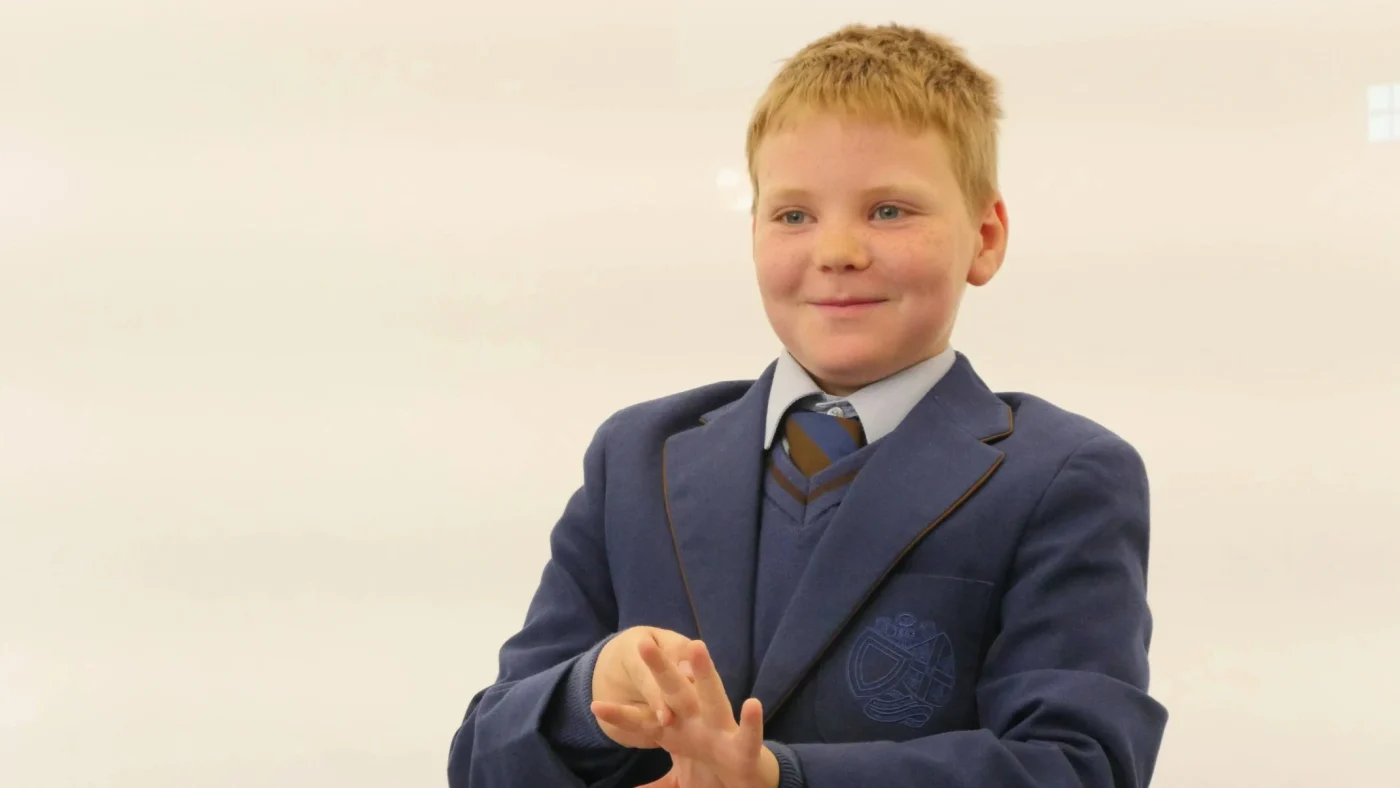 A Barney Prep School student signing.